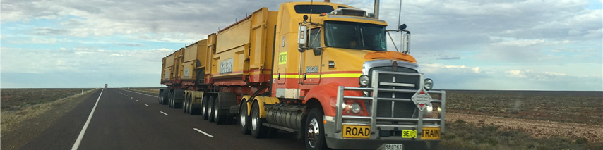 A large truck driving on an empty road